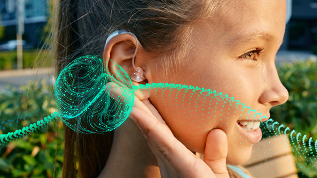 Image of adolescent female child with hearing aid in her ear