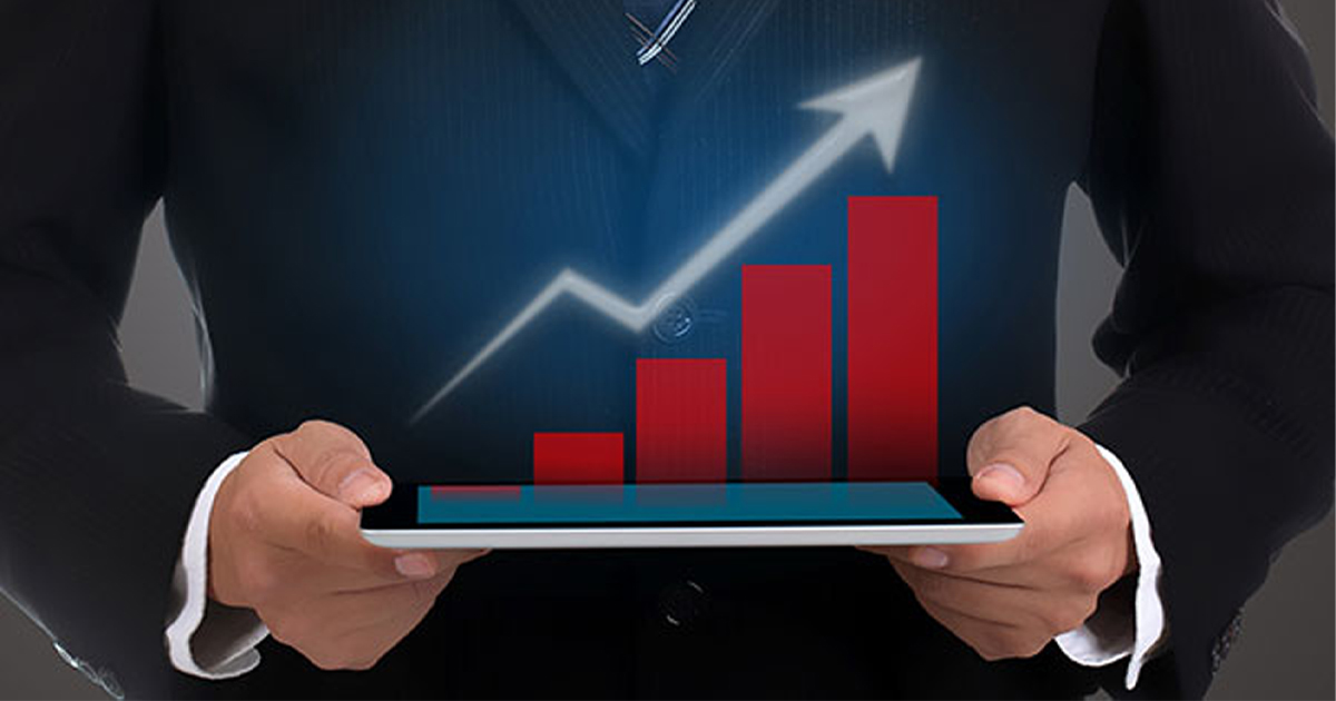 A businessman holds an imaginary bar graph with an upward trend.