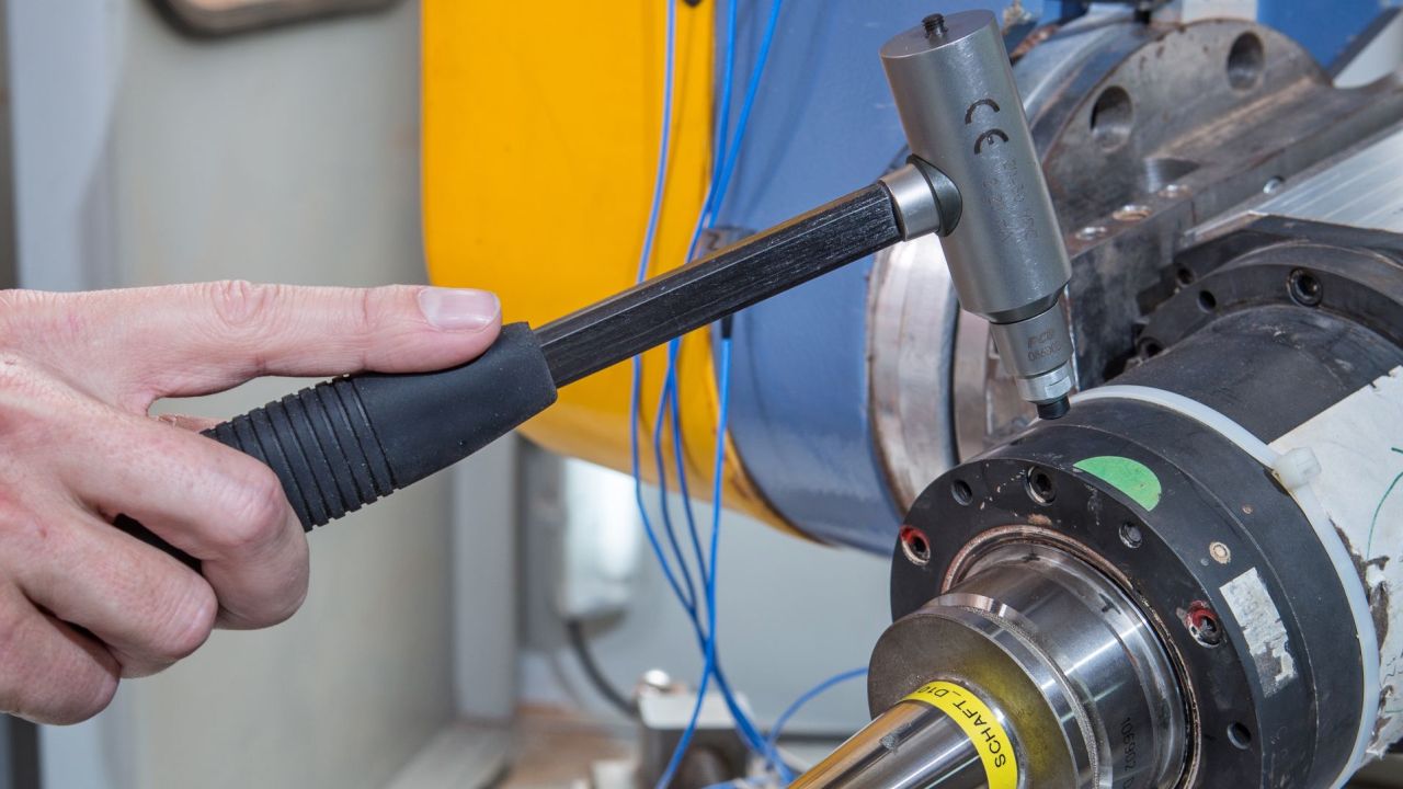 Man with testing device performing modal analysis