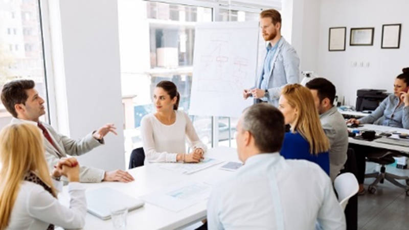 A group of individuals in a team collaborating on a new project idea.