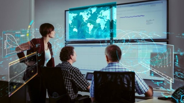 Woman and two men looking at graph and global map with data points digitally layered